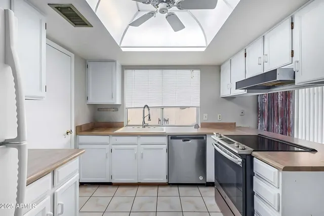 a kitchen with a sink stove and cabinets