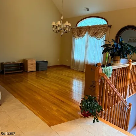 a view of a room with furniture and chandelier