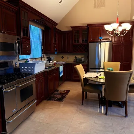 a kitchen with a sink cabinets and stainless steel appliances