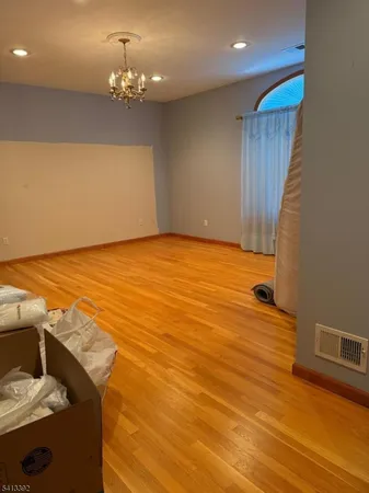 a view of a room with wooden floor