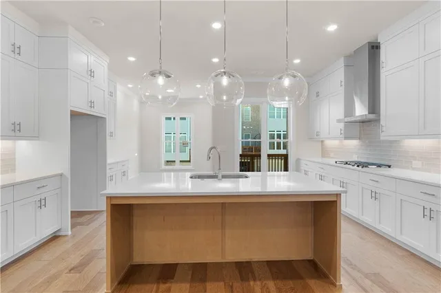 a large kitchen with a sink cabinets and stainless steel appliances