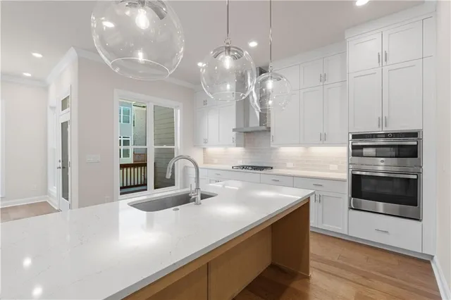 a kitchen with white cabinets and a stove