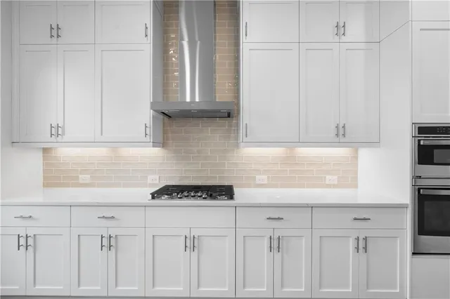 a kitchen with kitchen island a sink appliances and wooden floor