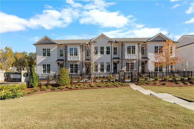 a front view of a residential apartment building with a yard