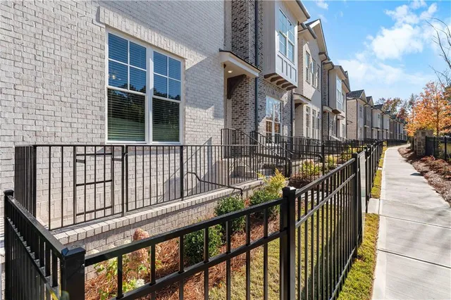 a view of an empty room with wooden floor fireplace and stairs