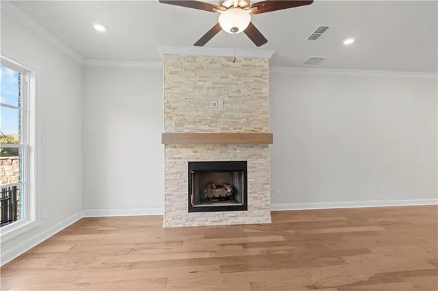 a view of a room with wooden floor and a ceiling fan