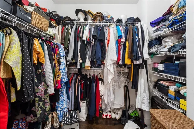 a view of walk in closet with clothes