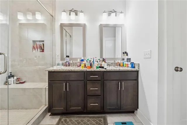 a bathroom with a sink vanity and mirror