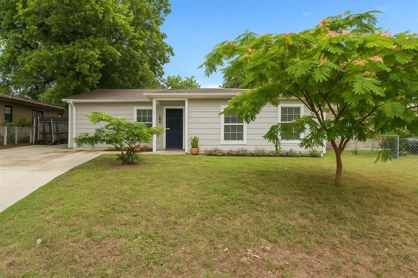 a backyard of a house with table and chairs