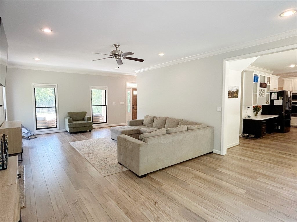 2004 Moores Mill Road Lanett, AL 36863 - Photo 14 of 50 This airy living space features warm flooring, crown molding, and an open layout to the kitchen.