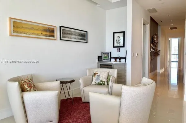 a view of a hallway to a livingroom with wooden floor