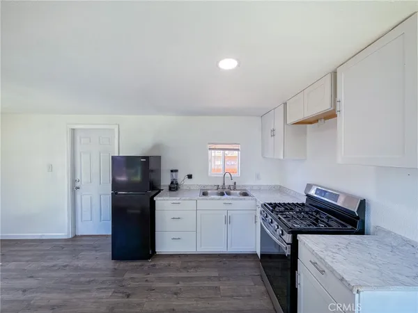 a kitchen with a stove a refrigerator and a sink
