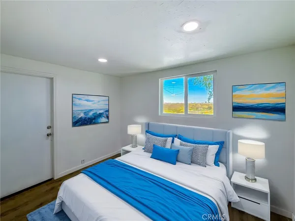 a bedroom with bed and a window