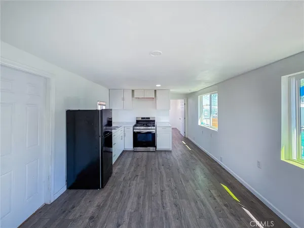 a kitchen with a refrigerator and a stove