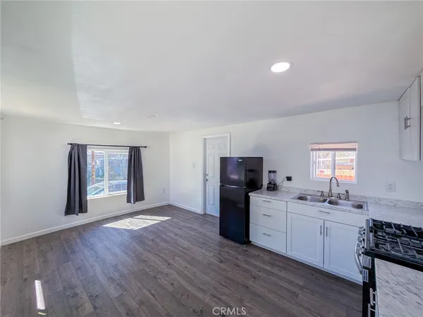 a kitchen with a refrigerator and a sink