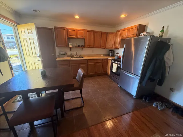 a kitchen with stainless steel appliances granite countertop a refrigerator a stove a sink dishwasher and a microwave