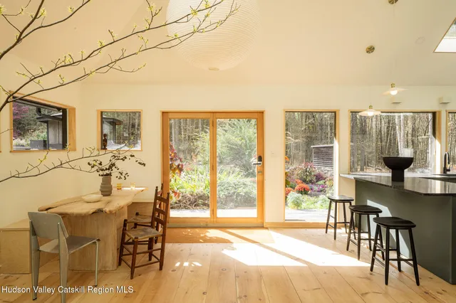 a view of a dining room with furniture and a floor to ceiling window