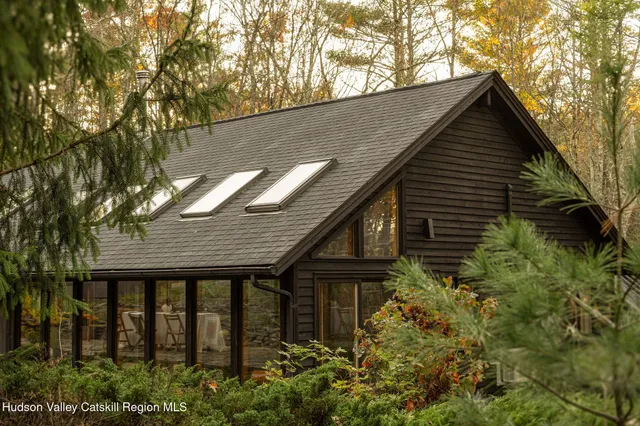 a backyard of a house with plants and tree