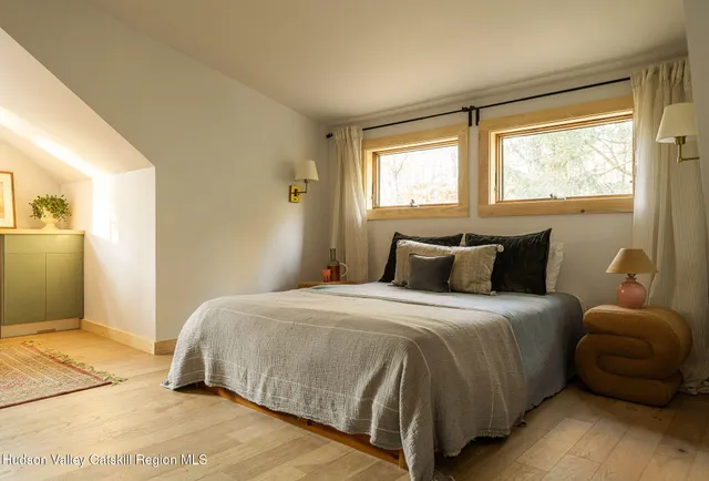 a view of a balcony with furniture and a potted plant