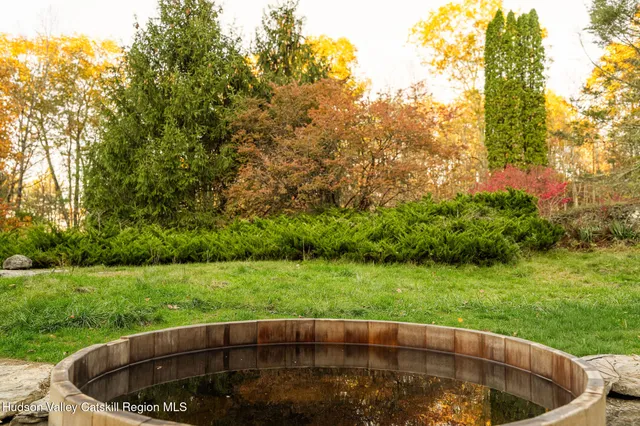 a backyard of a house with table and chairs