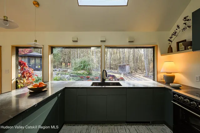 a kitchen with a sink and large window