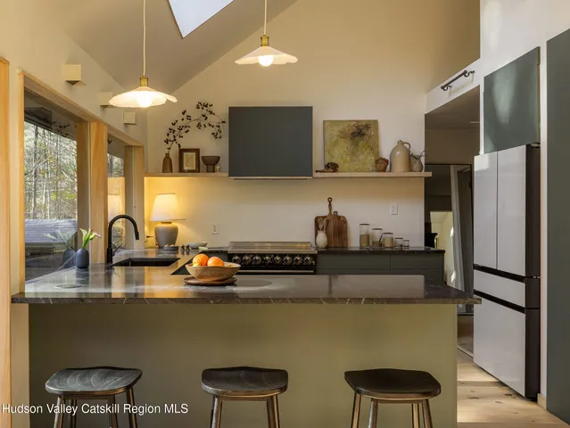 a kitchen with stainless steel appliances granite countertop a sink refrigerator and cabinets