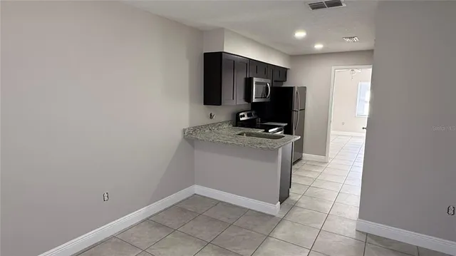 a kitchen with stainless steel appliances a refrigerator and a sink