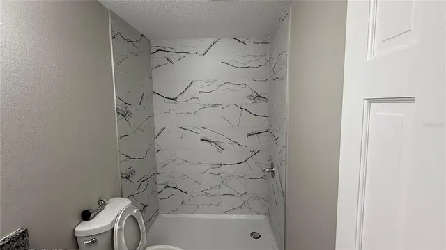 a bathroom with a bathtub and a shower