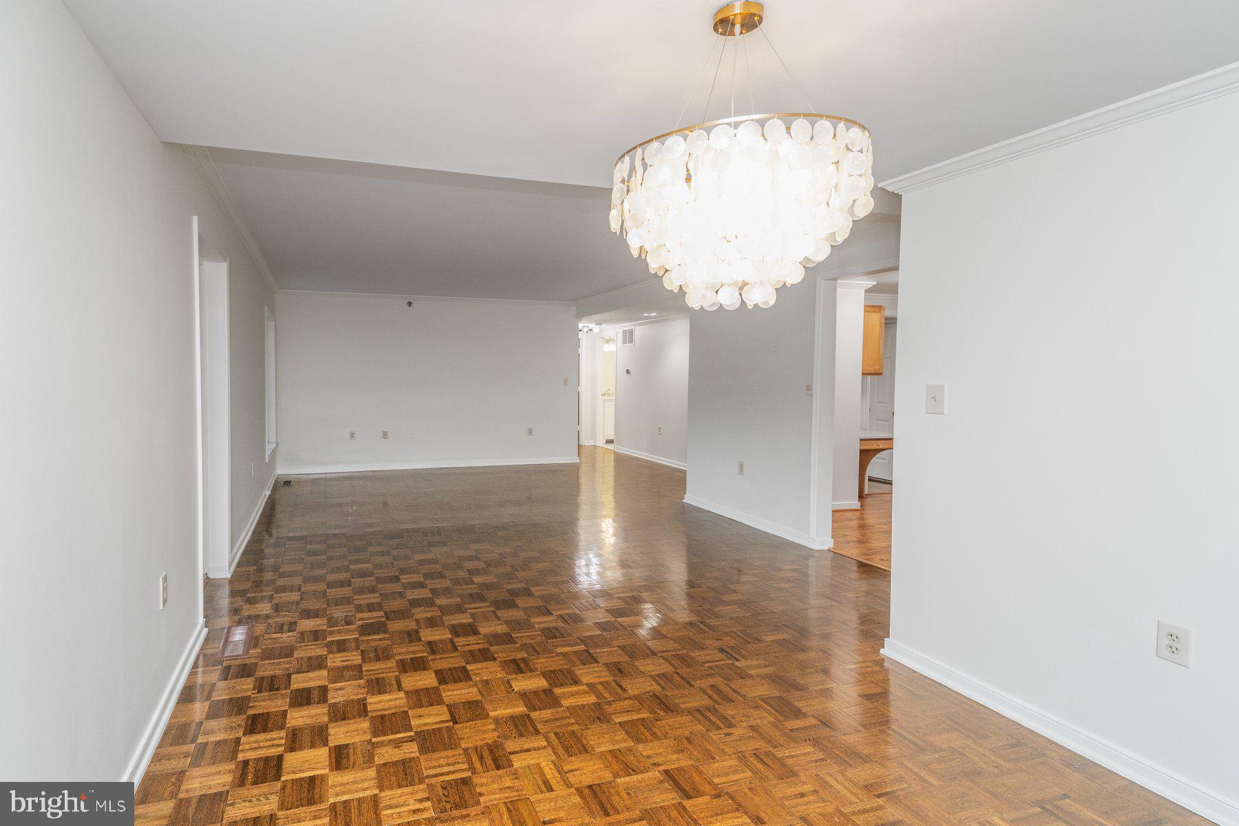 2331 Old Court Road, Unit 201 Baltimore, MD 21208 - Photo 11 of 38 a view of a hallway with a chandelier fan and wooden floor