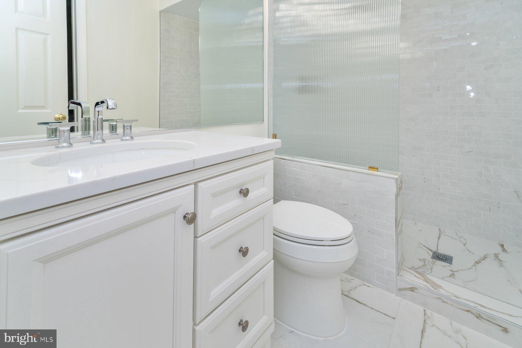 2331 Old Court Road, Unit 201 Baltimore, MD 21208 - Photo 13 of 38 a bathroom with a sink a toilet and a mirror