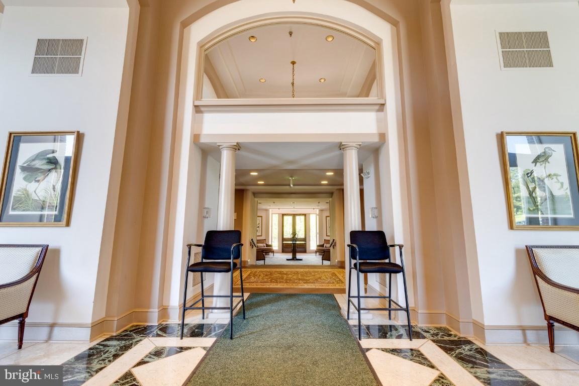 2331 Old Court Road, Unit 201 Baltimore, MD 21208 - Photo 23 of 38 a view of a hallway with couches and a dining table with painted walls