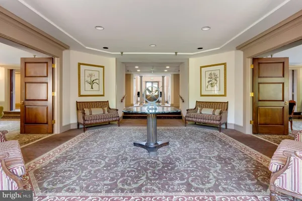 a living room with fireplace furniture and a rug