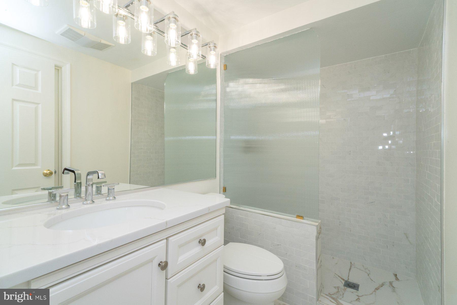 2331 Old Court Road, Unit 201 Baltimore, MD 21208 - Photo 3 of 38 a bathroom with a sink a toilet and shower