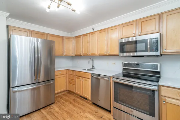 a kitchen with granite countertop a refrigerator stove and microwave
