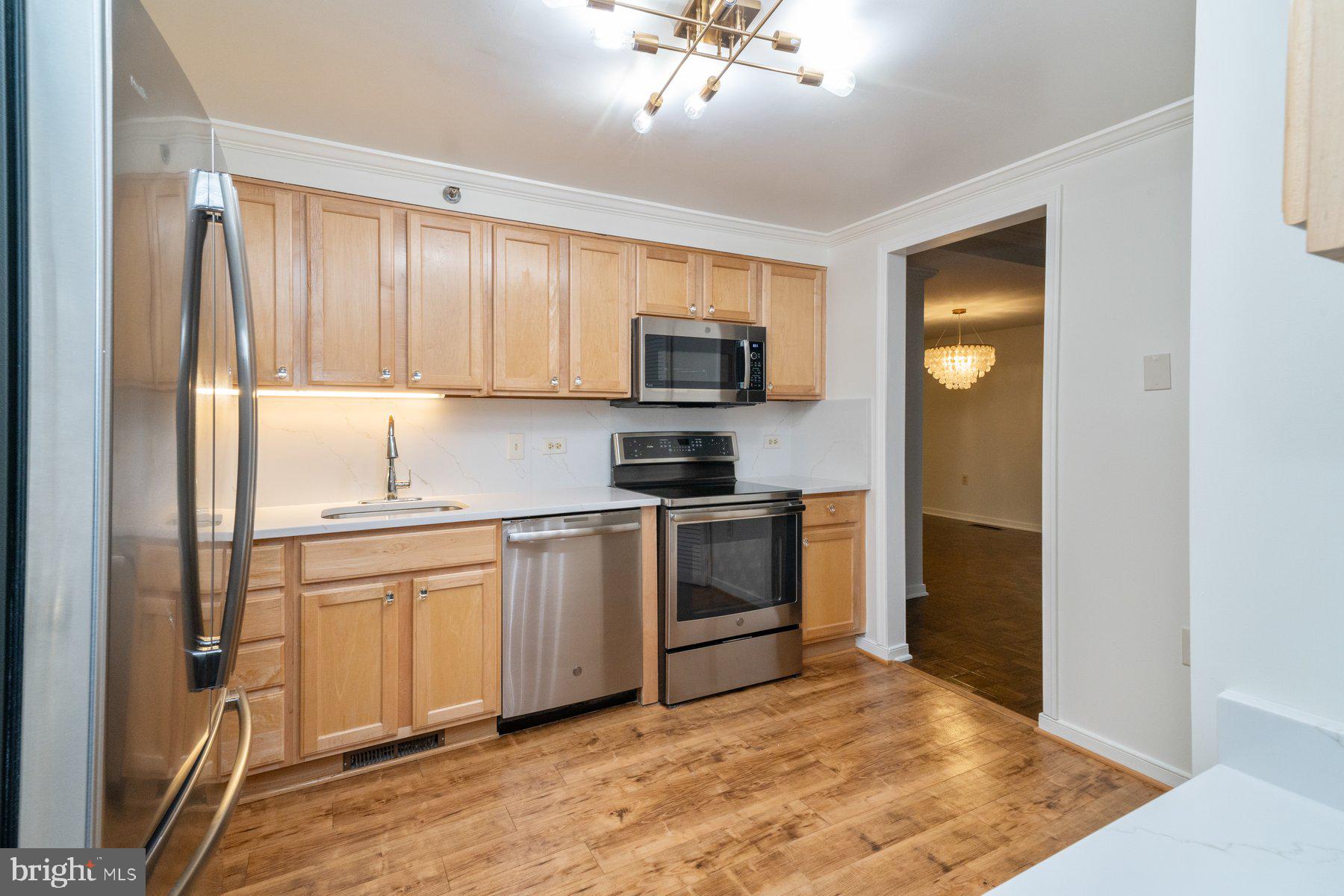 2331 Old Court Road, Unit 201 Baltimore, MD 21208 - Photo 9 of 38 a kitchen with a stove a sink and a refrigerator