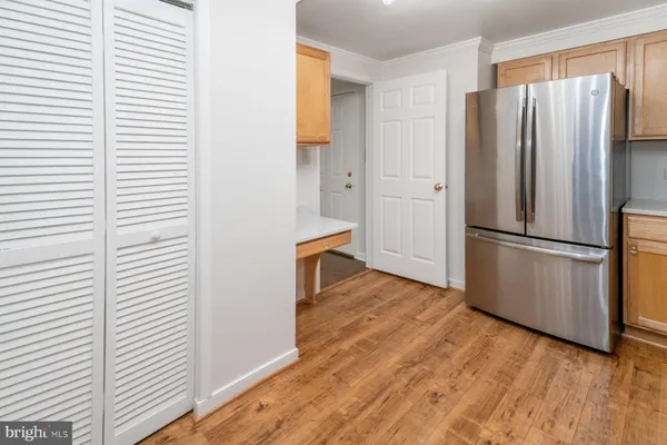 a view of a kitchen with wooden floor and electronic appliances