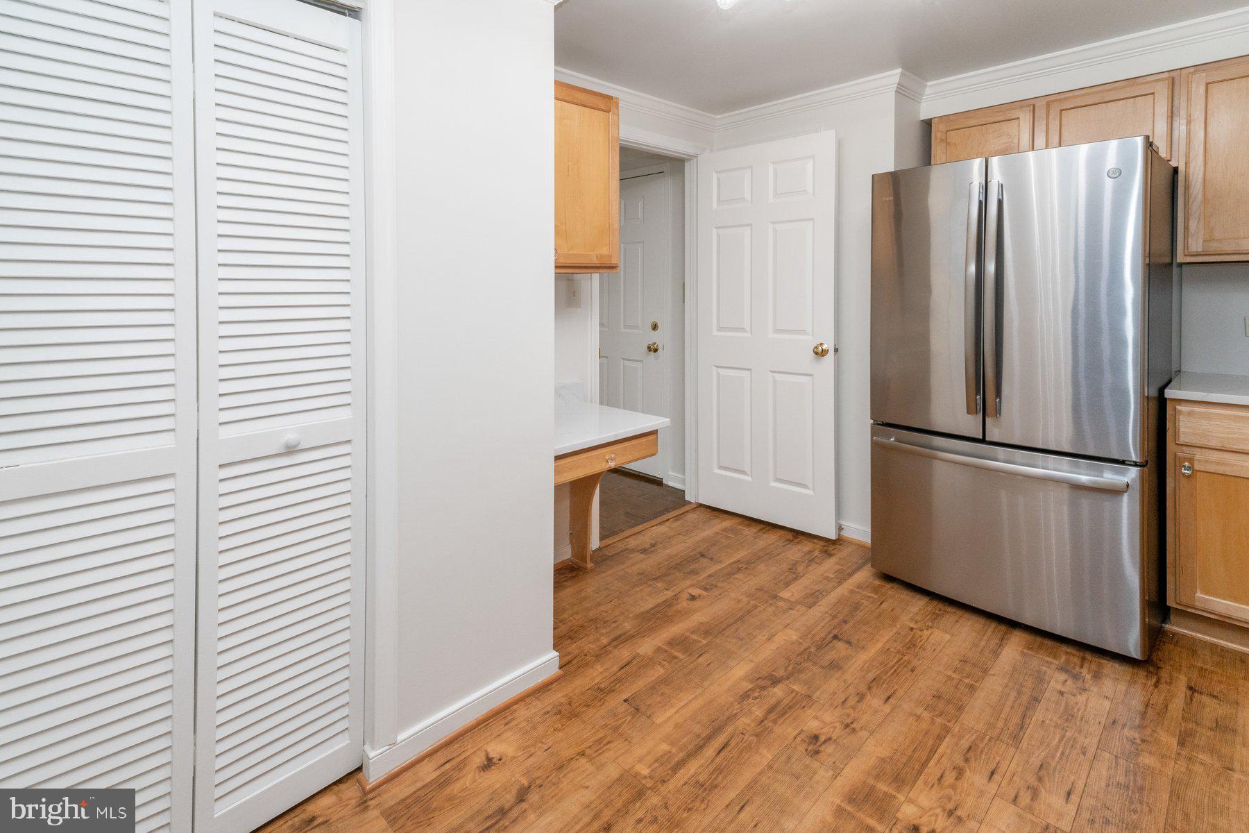 2331 Old Court Road, Unit 201 Baltimore, MD 21208 - Photo 10 of 38 a view of a kitchen with wooden floor and electronic appliances