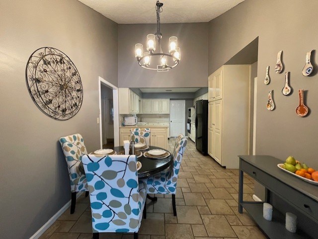 4537 Sears Road Columbus, GA 31907 - Photo 11 of 41 a dining room with furniture and a chandelier