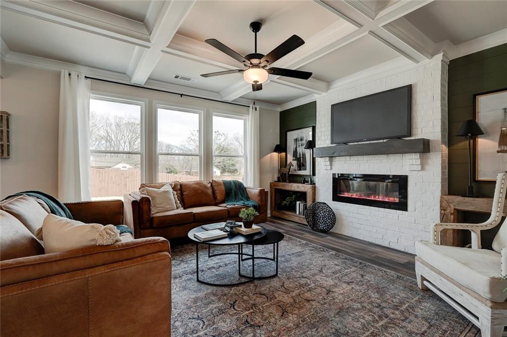 15 Cardinal Rdg Court Winder, GA 30680 - Photo 14 of 86 a living room with furniture a flat screen tv and a fireplace