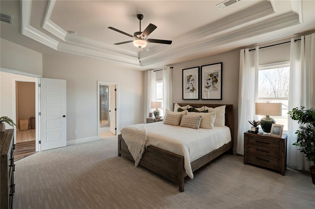15 Cardinal Rdg Court Winder, GA 30680 - Photo 28 of 86 a bedroom with a bed chandelier and a window