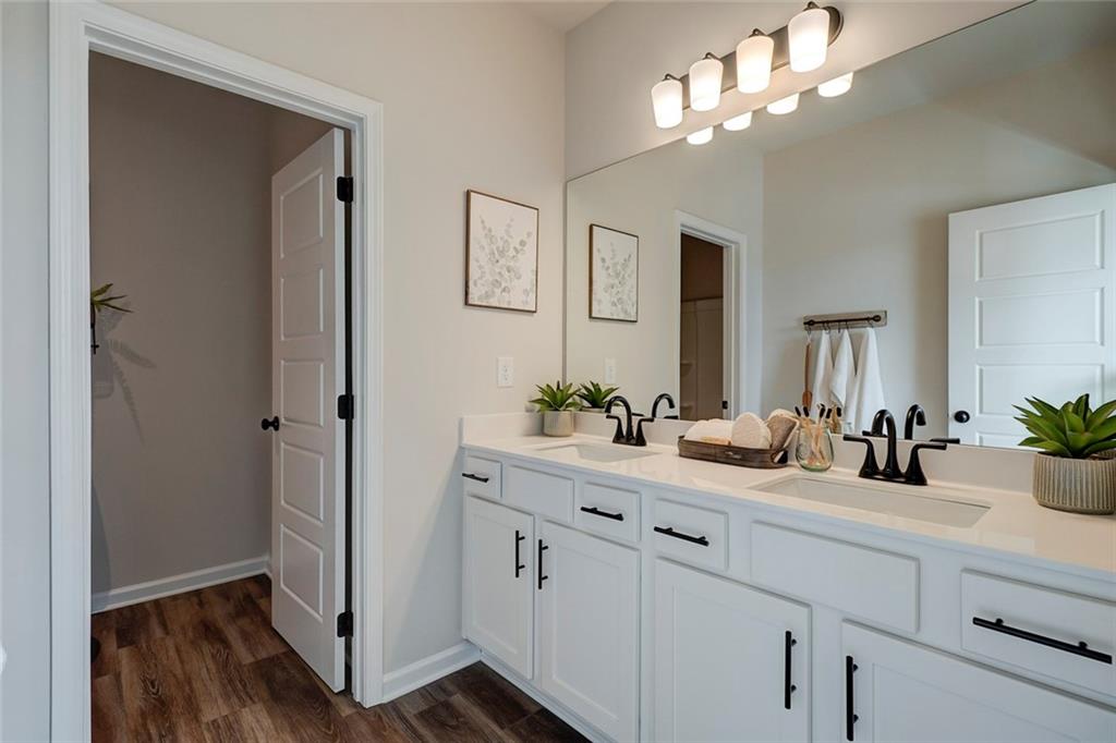 15 Cardinal Rdg Court Winder, GA 30680 - Photo 4 of 86 a bathroom with a sink a potted plant and a mirror
