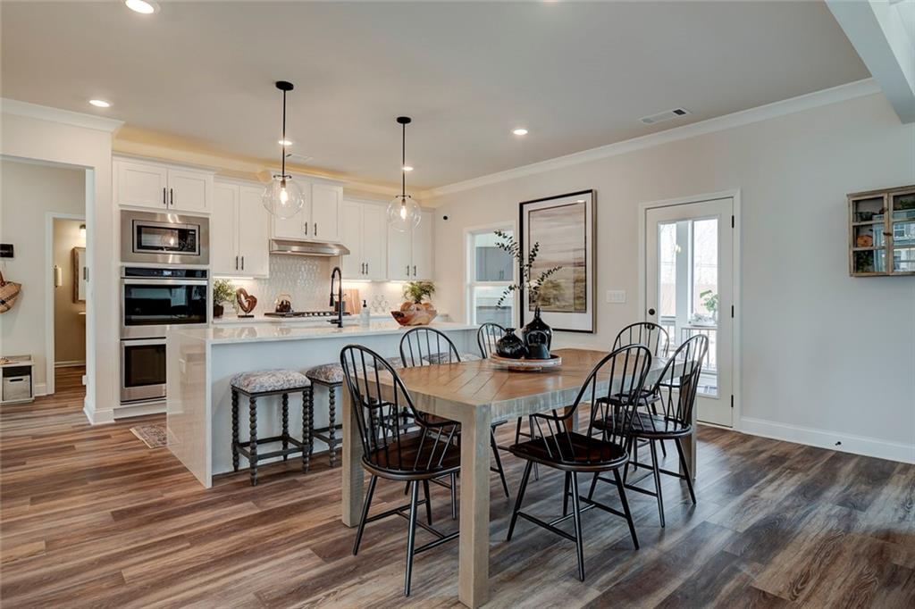 15 Cardinal Rdg Court Winder, GA 30680 - Photo 8 of 86 a view of a dining room with furniture and wooden floor