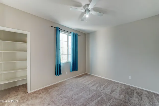 an empty room with a empty space and windows