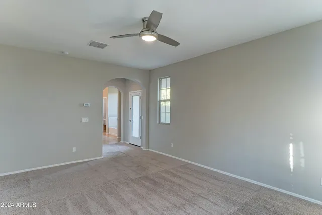 an empty room with closet and windows