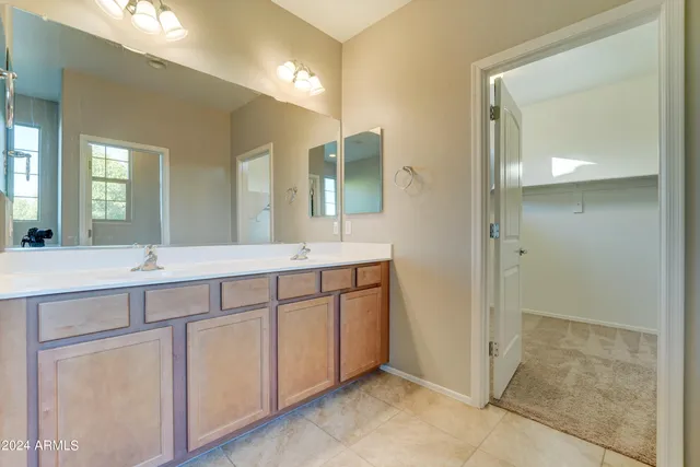 a bathroom with a double vanity sink and mirror