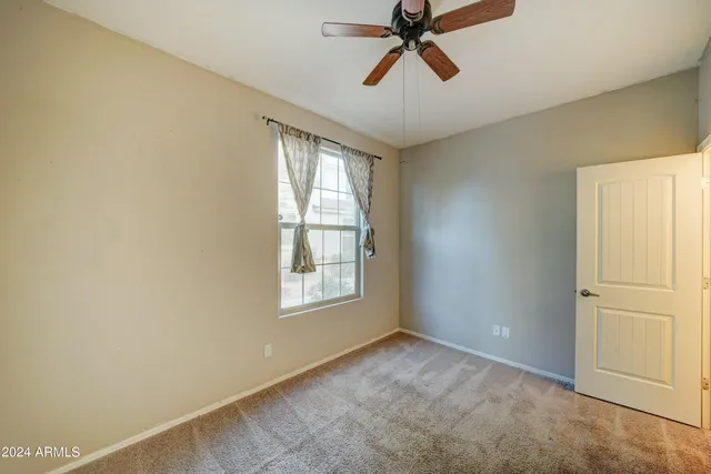 an empty room with windows and cabinet