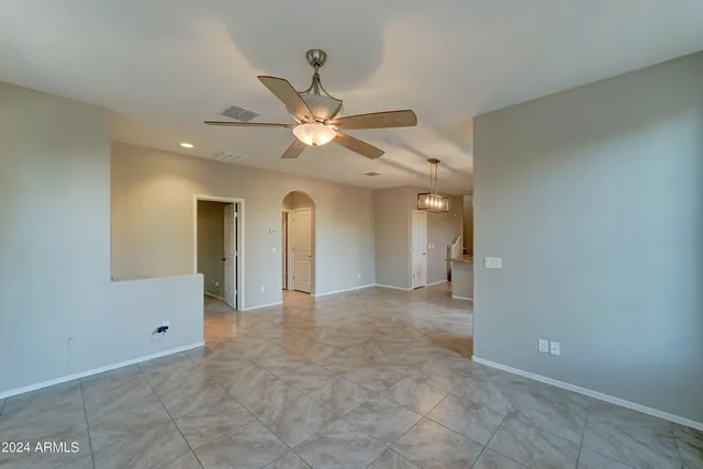 a view of a big room with wooden floor and a ceiling fan