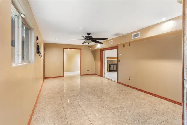 an empty room with a windows and cabinet