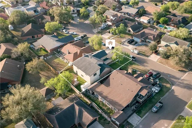 an aerial view of a residential houses with outdoor space