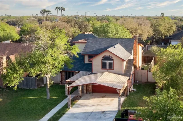 an aerial view of a house with a yard
